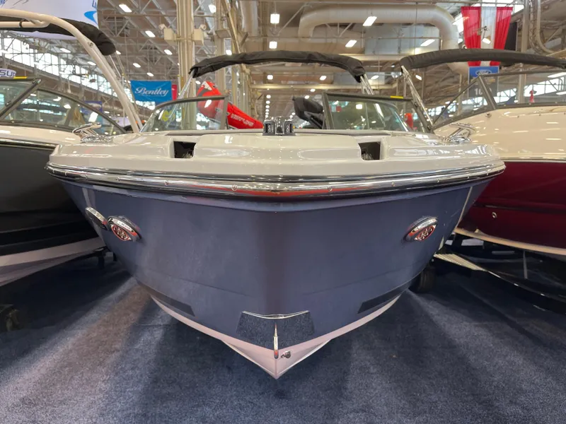 Slide: The Image of 2025 Monterey 218 SS boat displayed indoors at a showroom. - 3