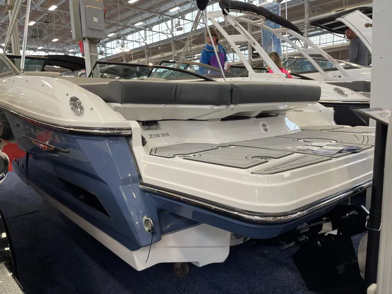 Slide: The Image of 2025 Monterey 218 SS boat displayed indoors, showcasing sleek design and modern features. - 4