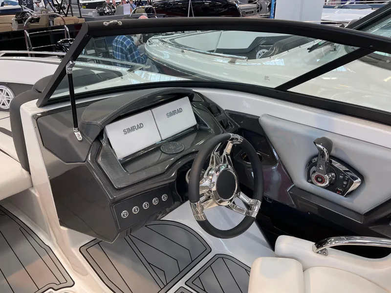 Slide: The Image of 2025 Monterey 238 SS boat dashboard with dual Simrad displays and sleek steering wheel. - 10