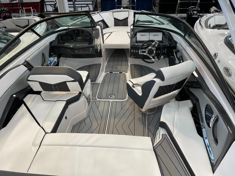Slide: The Image of 2025 Monterey 238 SS boat interior with sleek seating and modern dashboard design. - 7