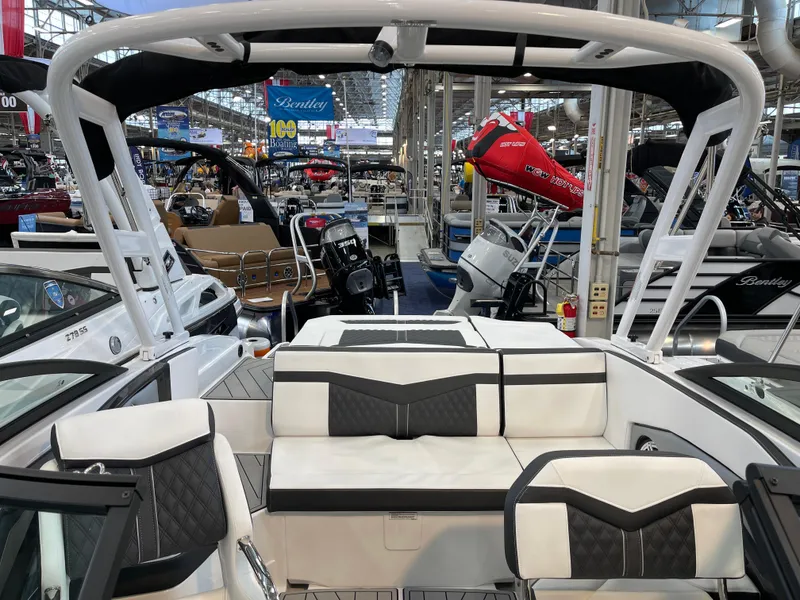 Slide: The Image of 2025 Monterey 238 SS boat interior at a showroom, featuring sleek seating and modern design. - 8