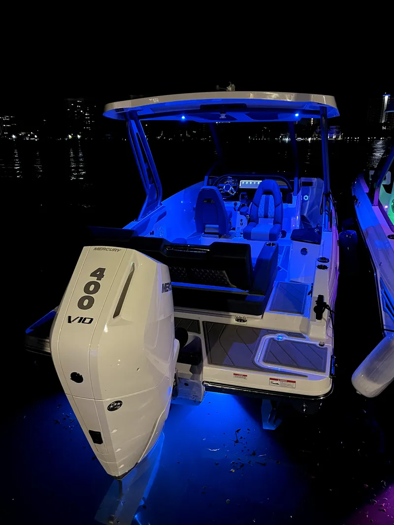 Slide: The Image of 2025 Monterey Elite 27 OB boat with blue LED lights at night. - 10