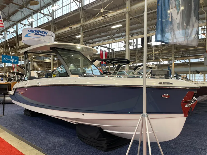 Slide: The Image of 2025 Monterey Elite 27 OB boat displayed indoors at Lakeview Marine showroom. - 11