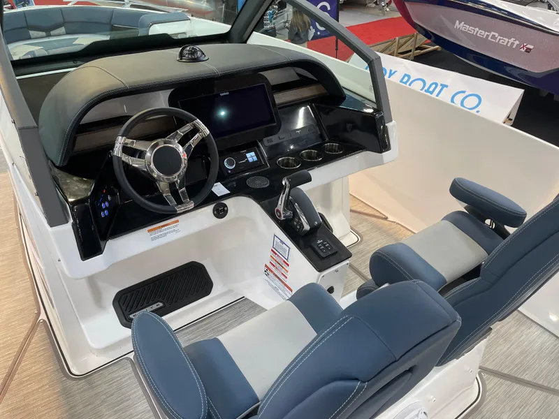 Slide: The Image of Cockpit of 2025 Monterey Elite 27 OB boat with modern steering and dual seating. - 14