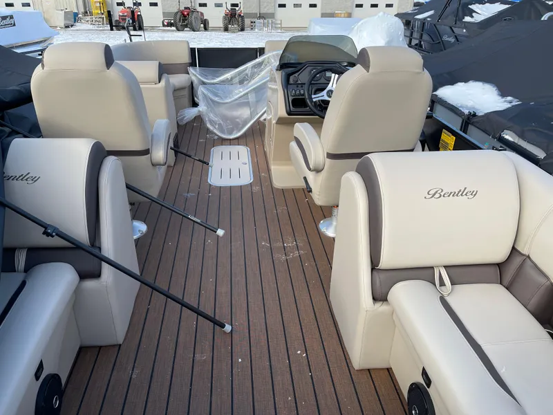Slide: The Image of 2025 Bentley Pontoons Legacy 223 Navigator interior with luxurious seating and wood-style flooring. - 10