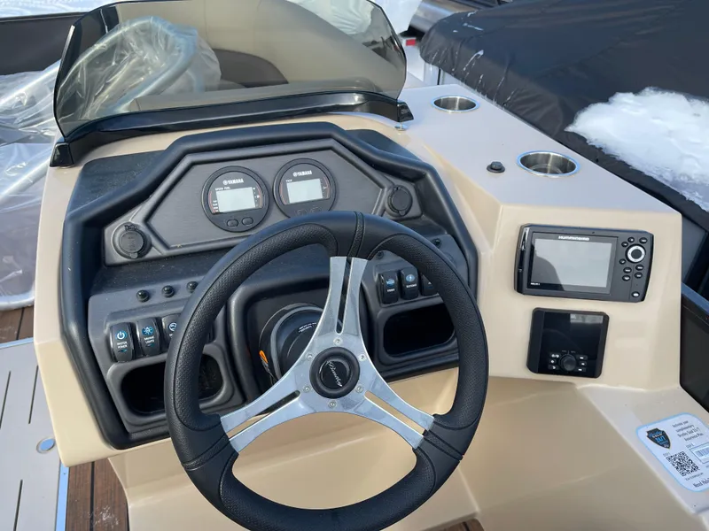 Slide: The Image of 2025 Bentley Pontoons Legacy 223 Navigator dashboard with steering wheel and controls. - 7