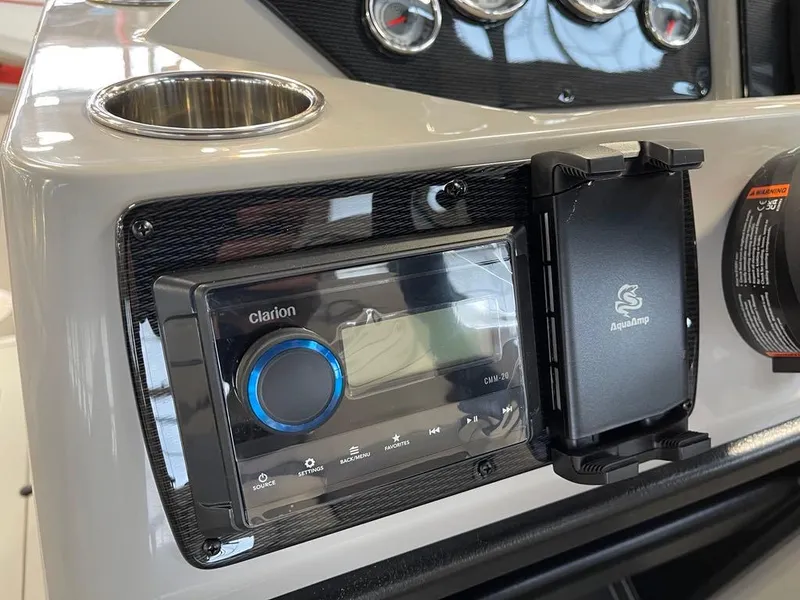 Slide: The Image of Dashboard of 2025 SunCatcher Select 322RC with Clarion audio system and cup holder. - 12