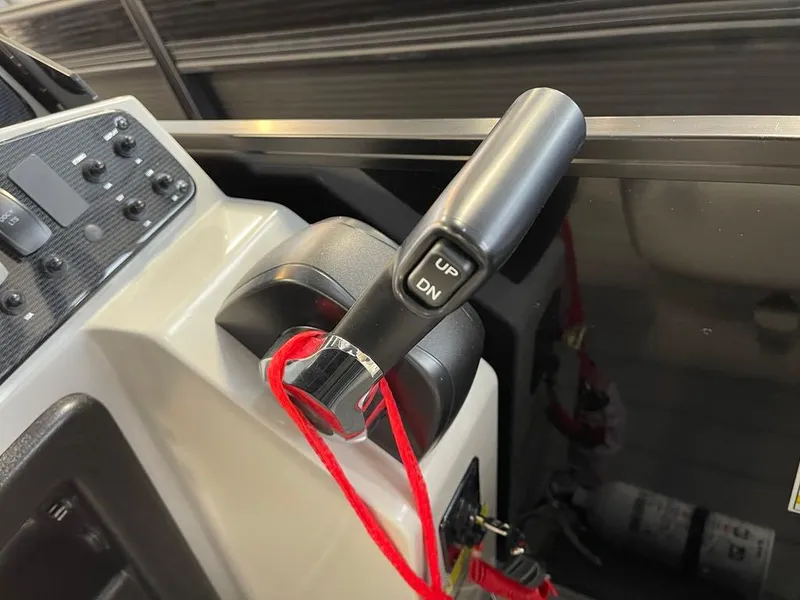 Slide: The Image of Control lever of 2025 SunCatcher Select 322RC boat with red safety cord. - 15