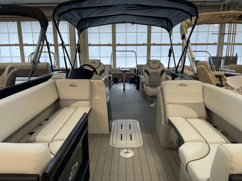 Slide: The Image of 2025 SunCatcher Select 322RC pontoon boat interior with spacious seating and canopy. - 2
