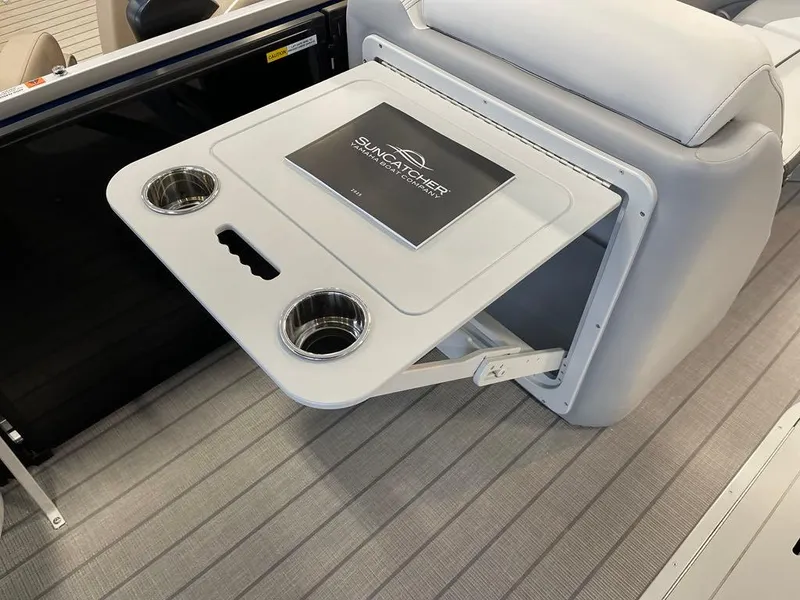 Slide: The Image of SunCatcher Select 322RC 2025 boat interior with foldable table and cup holders. - 7