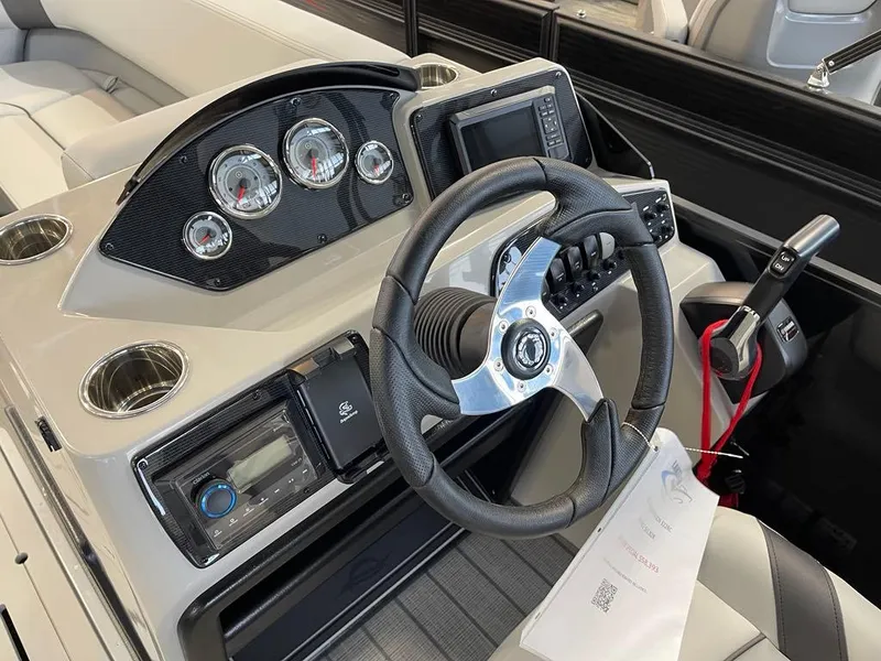 Slide: The Image of 2025 SunCatcher Select 322RC boat dashboard with steering wheel, gauges, and controls. - 9