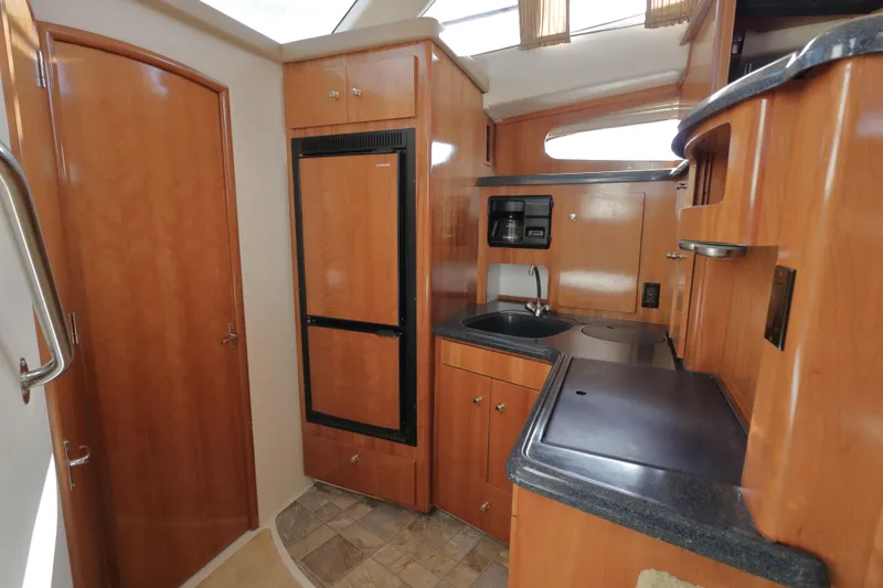 Slide: The Image of Interior of 2002 Carver 346 Motor Yacht with kitchen and wood paneling. - 15