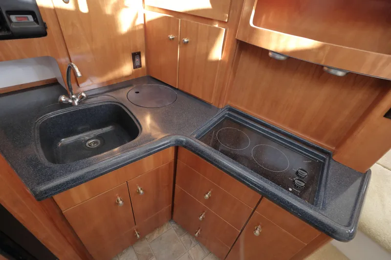 Slide: The Image of 2002 Carver 346 Motor Yacht kitchen area with sink and stove. - 17
