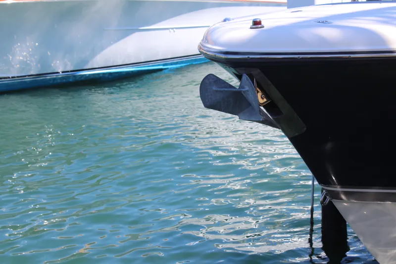 Slide: The Image of Bow of a 2008 Pursuit S 310 Sport boat with anchor, on calm water. - 11