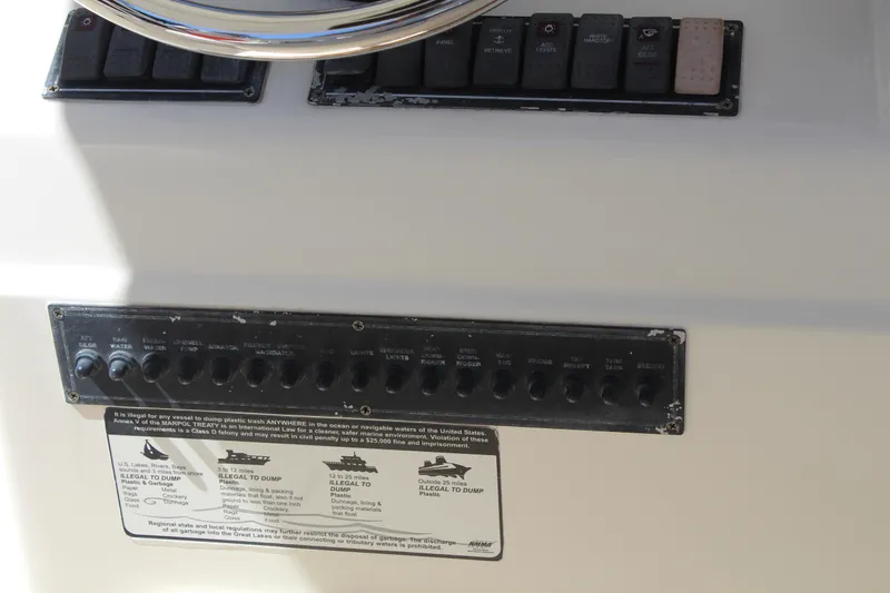 Slide: The Image of Control panel of a 2008 Pursuit S 310 Sport boat with switches and labels. - 17