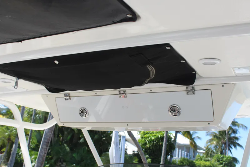 Slide: The Image of 2008 Pursuit S 310 Sport boat storage compartment with tropical background. - 20