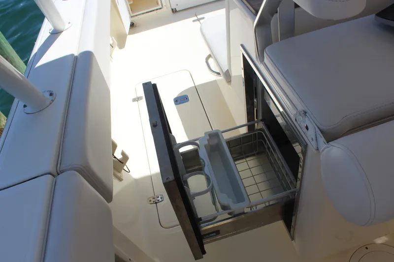 Slide: The Image of 2008 Pursuit S 310 Sport boat interior with open storage compartment and seating. - 23
