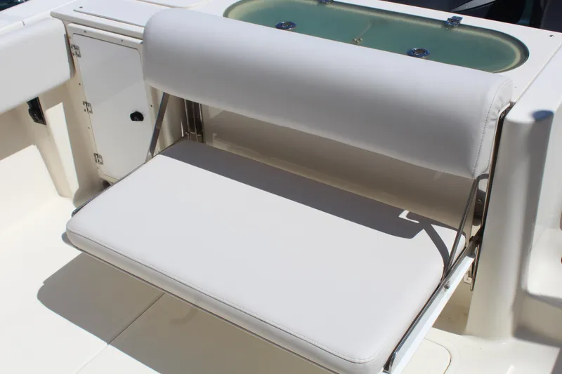Slide: The Image of 2008 Pursuit S 310 Sport boat with foldable white cushioned seat. - 24