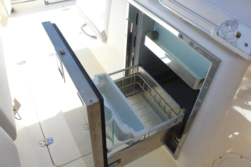 Slide: The Image of Open drawer refrigerator on 2008 Pursuit S 310 Sport boat, showcasing interior storage space. - 31