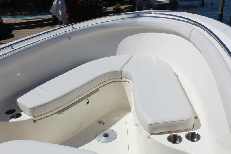 Slide: The Image of 2008 Pursuit S 310 Sport boat with white cushioned seating and stainless steel cup holders. - 32