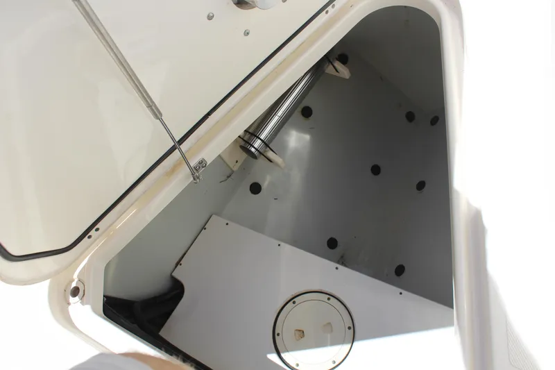 Slide: The Image of 2008 Pursuit S 310 Sport boat storage compartment with open hatch and hydraulic support. - 34