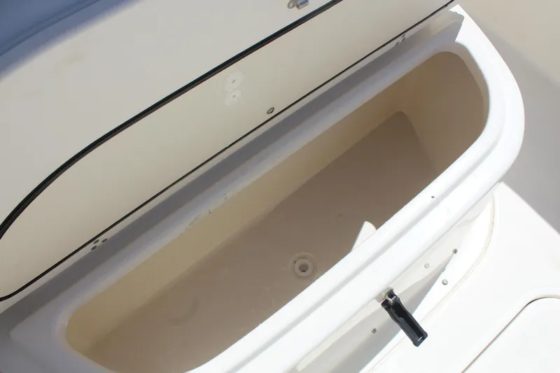 Slide: The Image of Open storage compartment on a 2008 Pursuit S 310 Sport boat. - 35