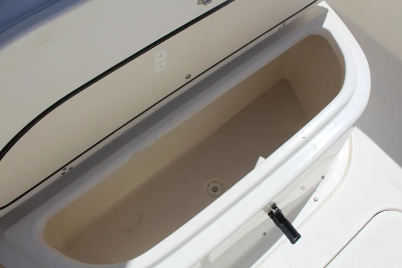 Slide: The Image of Open storage compartment on a 2008 Pursuit S 310 Sport boat. - 36