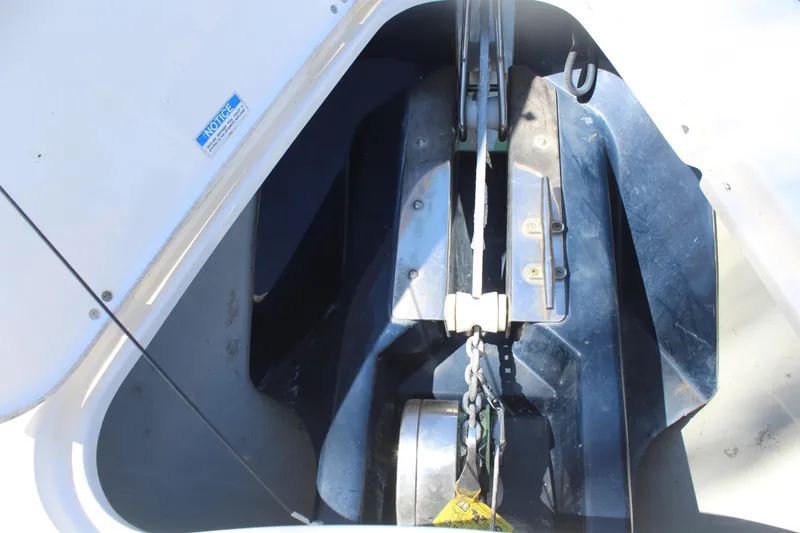 Slide: The Image of Anchor compartment of 2008 Pursuit S 310 Sport boat, showcasing chain and winch system. - 37