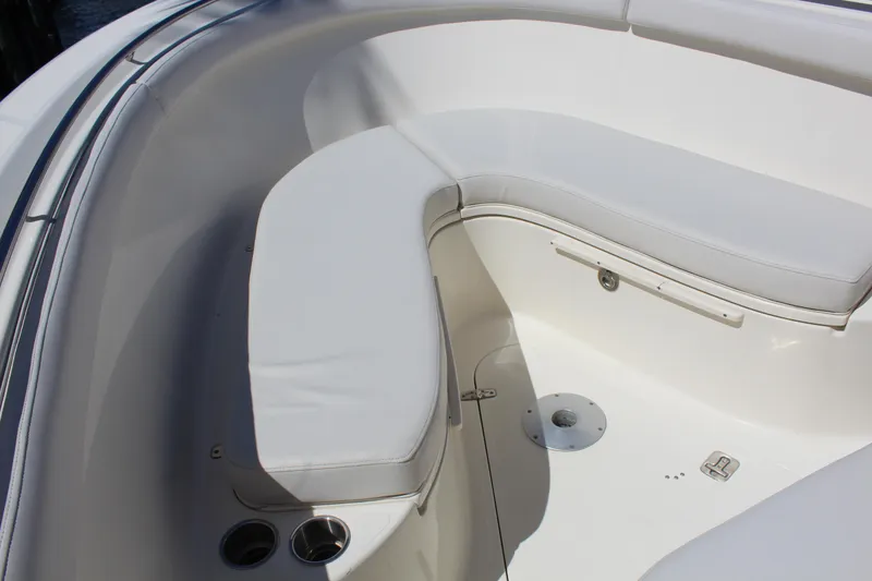 Slide: The Image of 2008 Pursuit S 310 Sport boat interior with white cushioned seating. - 38