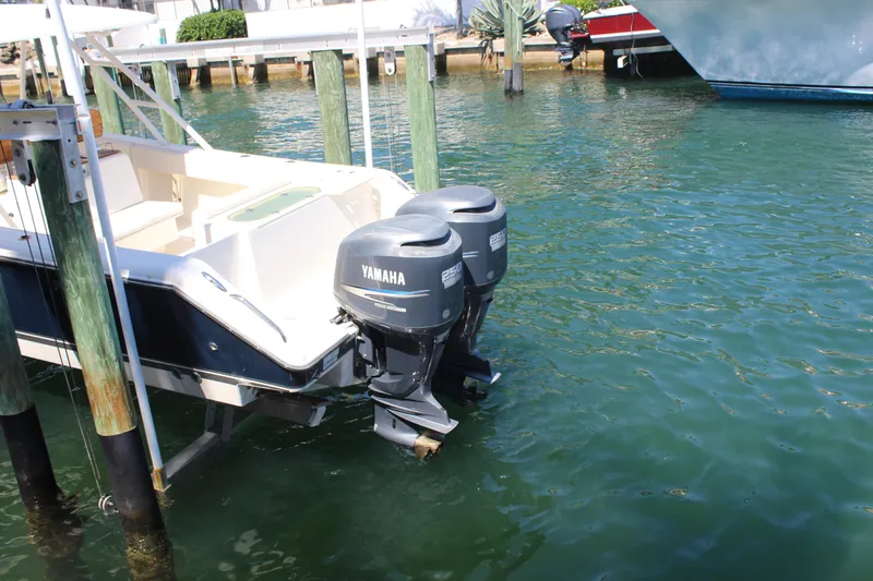 Slide: The Image of 2008 Pursuit S 310 Sport boat with twin Yamaha outboard motors docked in clear water. - 8