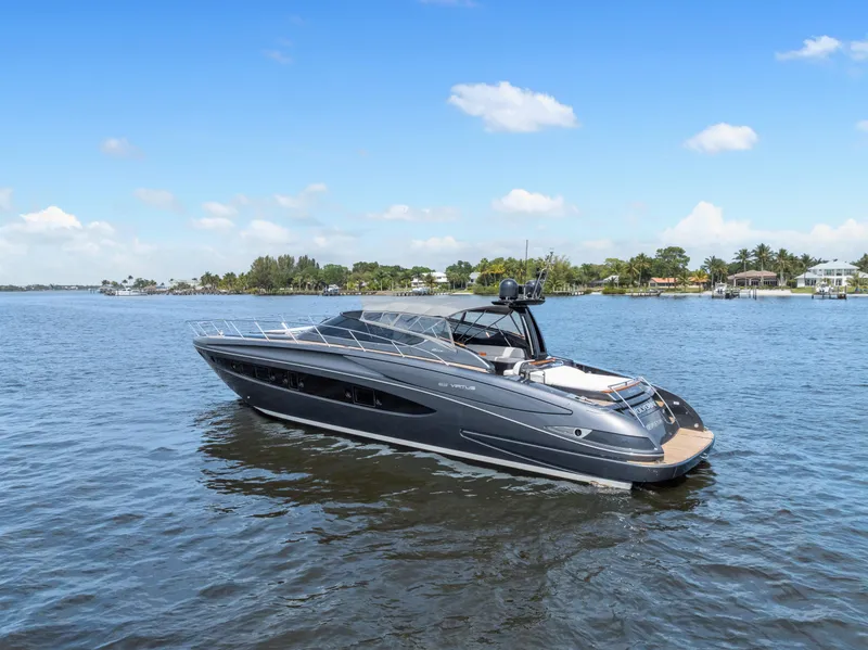 Slide: The Image of 2015 Riva 63 Virtus yacht on calm water under a clear blue sky. - 1