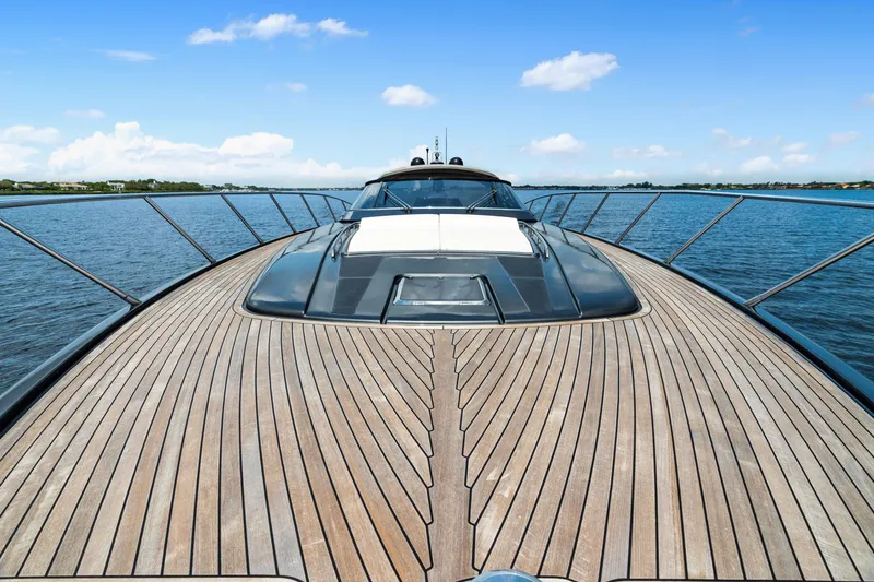 Slide: The Image of Luxurious 2015 Riva 63 Virtus yacht with sleek wooden deck on open water. - 12