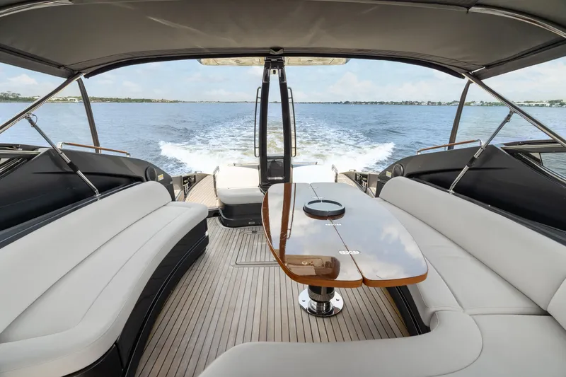 Slide: The Image of Luxurious 2015 Riva 63 Virtus yacht interior with elegant seating and table, cruising on open water. - 15