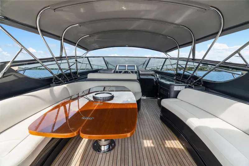 Slide: The Image of Luxurious 2015 Riva 63 Virtus yacht interior with elegant seating and wooden table. - 16