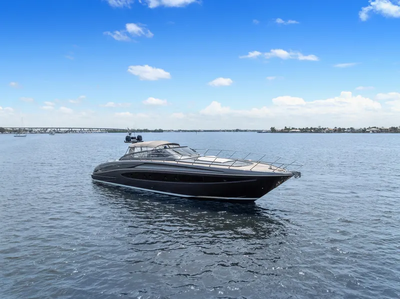 Slide: The Image of 2015 Riva 63 Virtus yacht on calm water under a clear blue sky. - 2