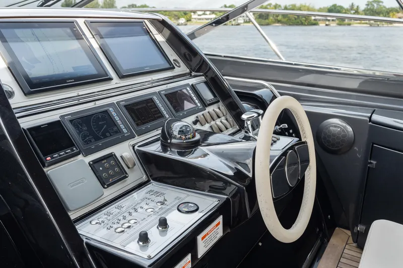 Slide: The Image of Cockpit of 2015 Riva 63 Virtus yacht with advanced navigation controls and steering wheel. - 21