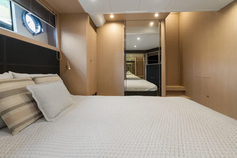 Slide: The Image of Luxurious bedroom interior on 2015 Riva 63 Virtus yacht, featuring elegant wood paneling. - 29