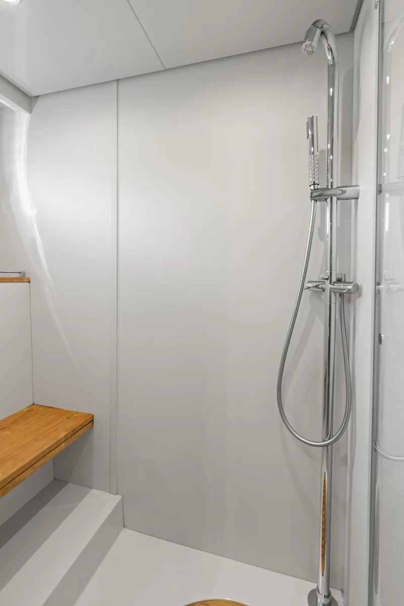 Slide: The Image of Shower area in 2015 Riva 63 Virtus yacht with sleek design and wooden bench. - 33