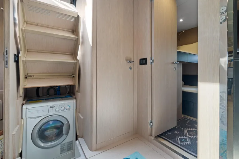 Slide: The Image of Laundry area inside 2015 Riva 63 Virtus yacht with washing machine and storage. - 40