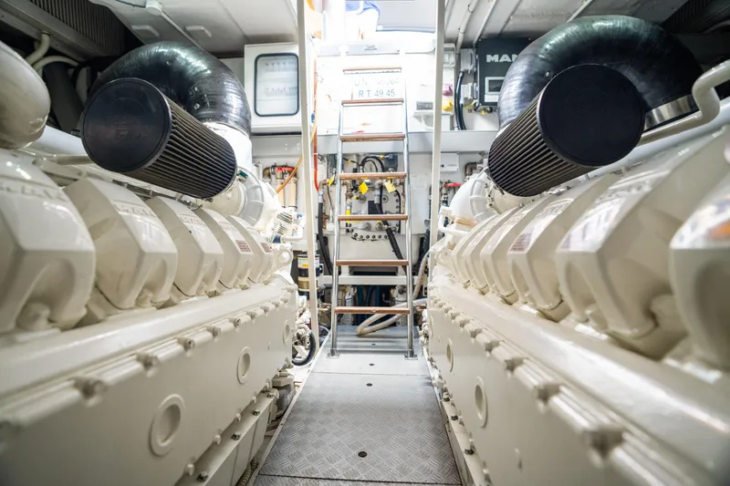 Slide: The Image of Engine room of a 2015 Riva 63 Virtus yacht, showcasing dual engines and mechanical components. - 43