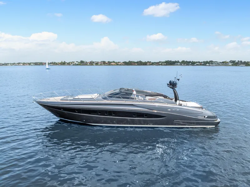 Slide: The Image of 2015 Riva 63 Virtus yacht cruising on calm blue waters under a clear sky. - 5