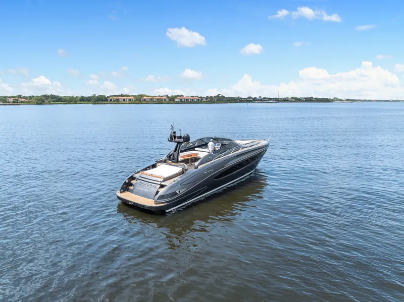 Slide: The Image of 2015 Riva 63 Virtus yacht on calm water under a clear blue sky. - 6