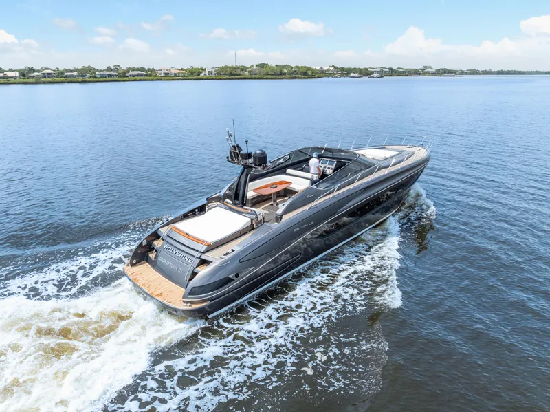 Slide: The Image of 2015 Riva 63 Virtus yacht cruising on a calm lake under a clear blue sky. - 8