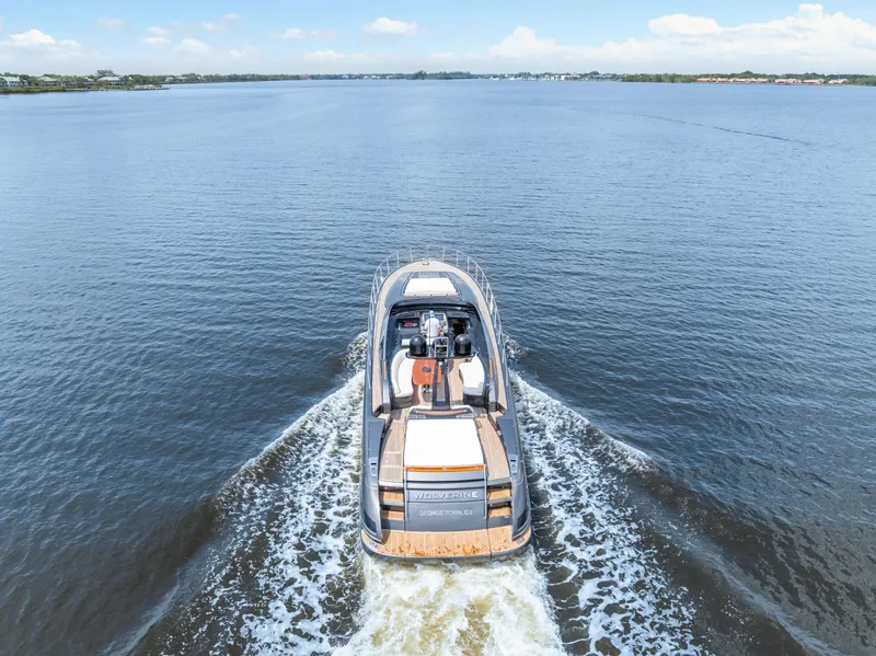 Slide: The Image of Riva 63 Virtus 2015 luxury yacht cruising on open water, rear view. - 9
