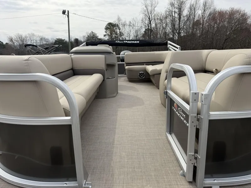 Slide: The Image of 2025 Sun Tracker Party Barge 18 DLX with beige seating and open deck layout. - 3