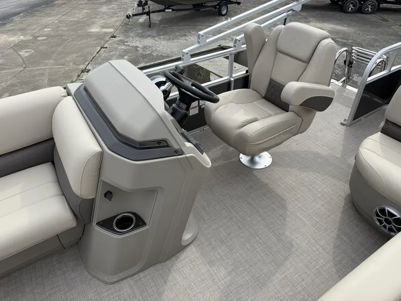Slide: The Image of 2025 Sun Tracker Party Barge 18 DLX interior with captain's chair and steering console. - 7