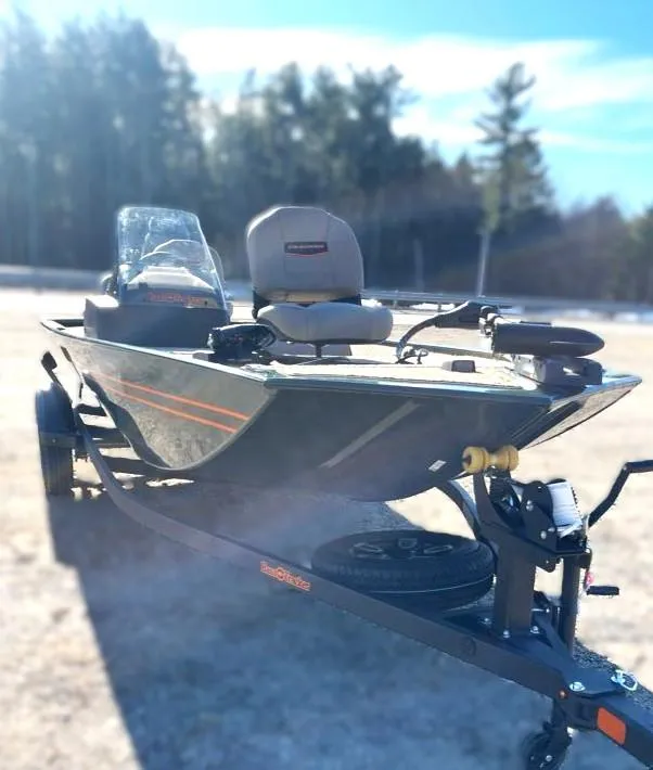 Slide: The Image of 2025 Tracker Bass Tracker Classic Limited boat on trailer in sunny outdoor setting. - 2
