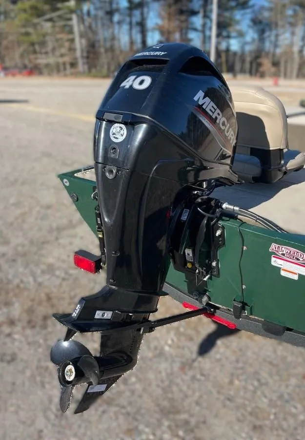 Slide: The Image of 2025 Tracker Bass Tracker Classic Limited with Mercury 40 outboard motor in a sunny outdoor setting. - 3