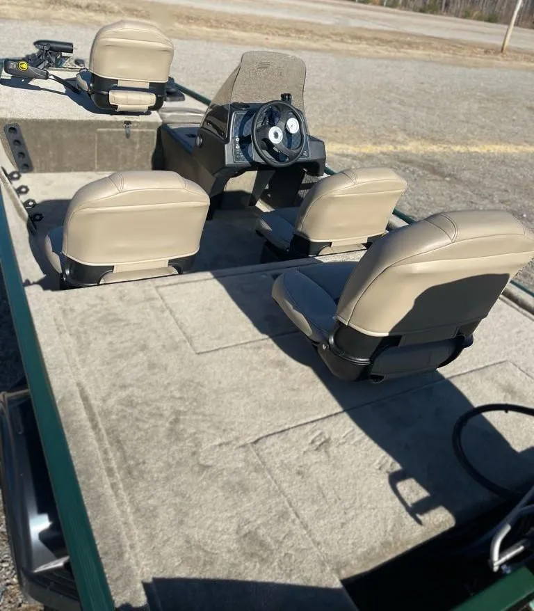 Slide: The Image of 2025 Tracker Bass Tracker Classic Limited boat interior with beige seats and steering console. - 6