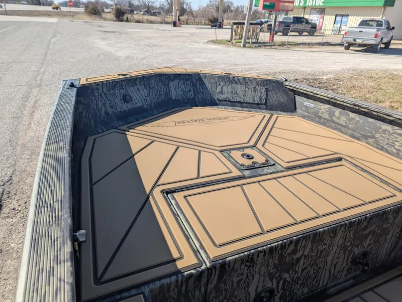 Slide: The Image of 2025 Tracker Grizzly 1650 T Prairie Wings Edition boat with camo design and spacious deck. - 11